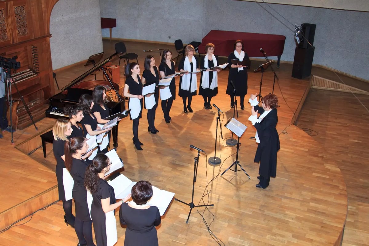 Yerevan Voices performing in a concert hall with organ and grand piano